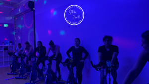 Participants engaging in Booty with a Spin class at Studio Flex45, focusing on glute and leg sculpting exercises.