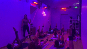 Woman lifting dumbbells in a yoga sculpt class at Studio Flex45