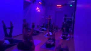 Woman practicing yoga in sunlit studio at Studio Flex45 Ventura