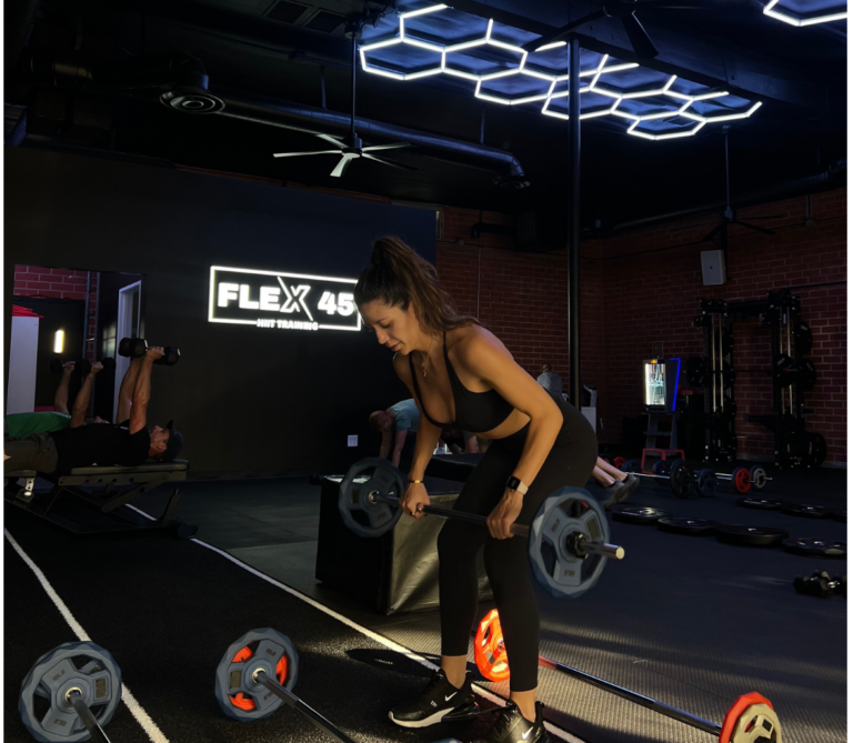 Woman performing strength training in a coach-led fitness class in Thousand Oaks